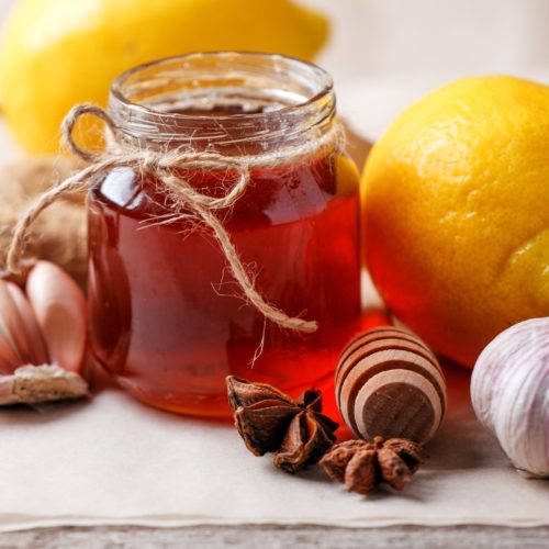 Homemade antimicrobial therapy. Ingredients for healthy tea with herbs, honey, ginger, garlic and lemon, seasonal traditional flu remedy drink