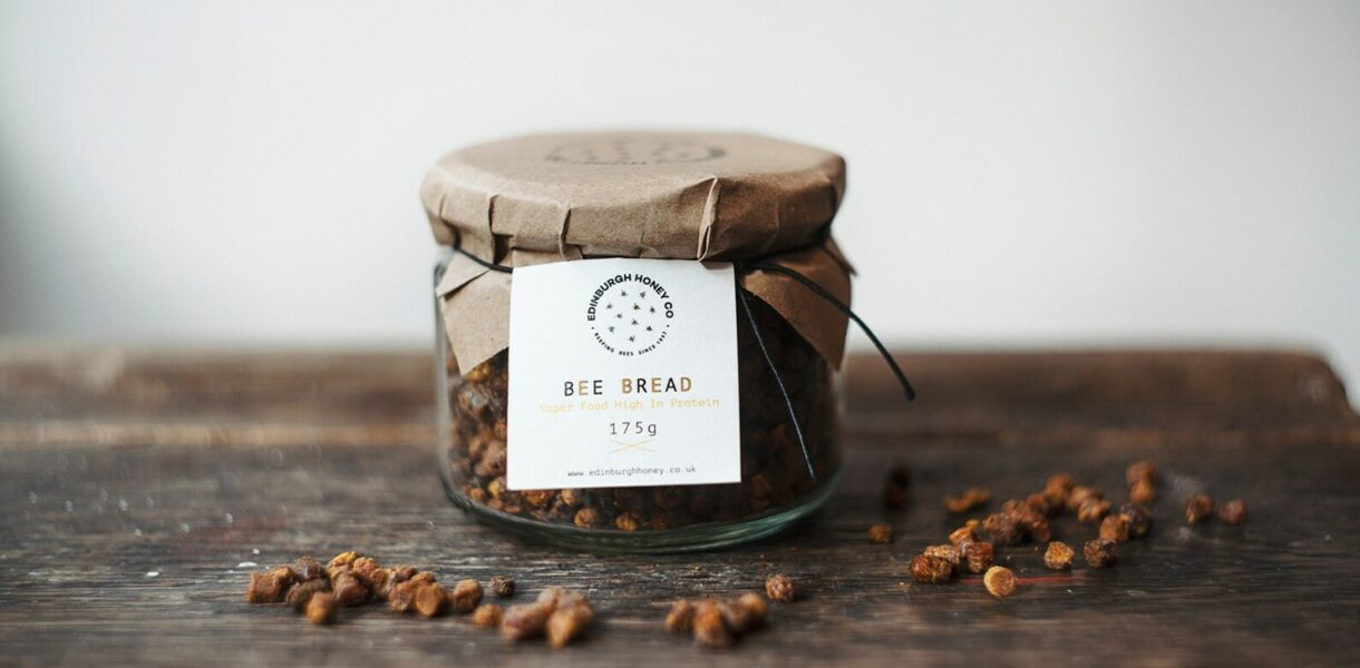Bee bread in a glass jar, showing naturally fermented pollen granules