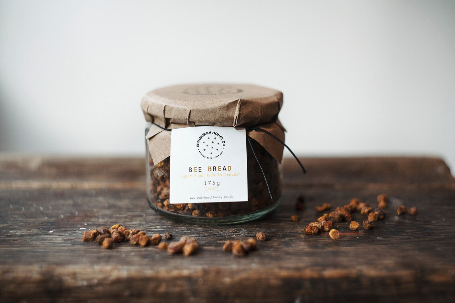 Bee bread in a glass jar, showing naturally fermented pollen granules